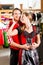 Couple is trying Dirndl or Lederhosen in a shop