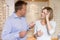 Couple trying on eyeglasses at optometrists