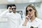 Couple trying on sunglasses in optical eyeglasses store