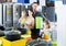 couple with two children picking new kitchenware in home appliances shop