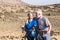 Couple of two seniors together in the mountains riding with their mountain bikes - happy, healthy and fitness lifestyle - woman