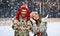 Couple in ugly sweaters on christmas ice rink