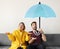 Couple under an umbrella icon