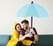 Couple under an umbrella icon