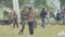 Couple under umbrella on lawn at city crowded park summer festival