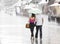 Couple under umbrella walking in heavy summer rain