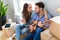 Couple with unpacked boxes in new home