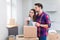 Couple with unpacked boxes in new home