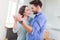 Couple with unpacked boxes in new home