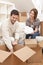 Couple Unpacking or Packing Boxes Moving House