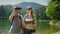 The couple uses a tablet while traveling to the lake and mountains. A man looks through binoculars, a woman on a map on