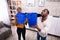 Couple Using Bucket For Collecting Water Leakage