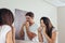 Couple using dental floss to clean their teeth