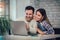 Couple Using Laptop On Desk At Home
