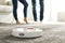 Couple using robotic vacuum cleaner