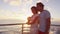 Couple using smart phone screen on sunset cruise ship sailing in ocean