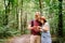 Couple using smart phone to navigate in woods. Theme tourism and navigation, search way, create route, gps phone app. Two people