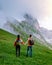 Couple on vacation hiking in the Italien Dolomites, Amazing view on Seceda peak. Trentino Alto Adige, Dolomites Alps