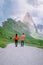 Couple on vacation hiking in the Italien Dolomites, Amazing view on Seceda peak. Trentino Alto Adige, Dolomites Alps