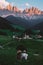 couple on vacation in the Italian Dolomites, Santa Maddalenavillage with magical Dolomites mountains in autumn, Val di