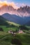 couple on vacation in the Italian Dolomites,Santa Magdalena village with magical Dolomites mountains in autumn, Val di