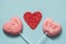Couple valentine lollipops pink pops on pastel blue. Funny concept. Copy space. Close up