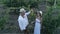 Couple at vineyard, view from height on man and girl are looking at bunch of ripe grapes at countryside