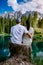 Couple visit hte bleu lake in the dolomites Italy, Carezza lake Lago di Carezza, Karersee with Mount Latemar, Bolzano