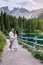 Couple visit hte bleu lake in the dolomites Italy, Carezza lake Lago di Carezza, Karersee with Mount Latemar, Bolzano