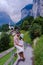 Couple visit Lauterbrunnen valley with waterfall and Swiss Alps in the background Switzerland