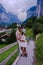 Couple visit Lauterbrunnen valley with waterfall and Swiss Alps in the background Switzerland