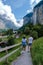 Couple visit Lauterbrunnen valley with waterfall and Swiss Alps in the background Switzerland