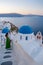 Couple visit Santorini Greece, men and women visit the whitewashed Greek village of Oia