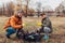 Couple of volunteers cleaned up the trash in park. People picked up garbage and showing result with thumb up. Ecology