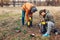 Couple of volunteers cleaning up the trash in park. Picking up garbage outdoors. Ecology and environment concept