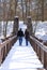 Couple Walking Across A Bridge Holding Hands