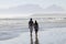 Couple walking along beach in South Africa