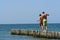 Couple walking along a pier