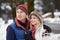 Couple Walking Along Snowy Street In Ski Resort