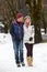 Couple Walking Along Snowy Street In Ski Resort