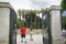 Couple walking away through open gate of Greece National Garden