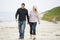 Couple walking at beach holding hands