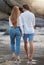 Couple walking on beach, holding hands and travel with love and commitment in relationship, adventure and romance. Trust