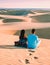 couple walking at the beach of Maspalomas Gran Canaria Spain, men and woman at the sand dunes desert