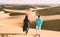 couple walking at the beach of Maspalomas Gran Canaria Spain, men and woman at the sand dunes desert