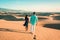 couple walking at the beach of Maspalomas Gran Canaria Spain, men and woman at the sand dunes desert of Maspalomas