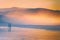 Couple walking on beach at sunset