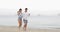 Couple Walking On Beach Using Cell Smart Phones Taking Selfie Holding Hands, Young Man Woman Tourists Networking Online
