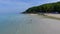 Couple walking on beach. Young happy interracial couple walking on beach smiling holding around each other. Senior