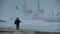 Couple walking on cloudy coast.